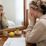 Girl with comedonal acne crying infront of mirror and thinking of using home remedies